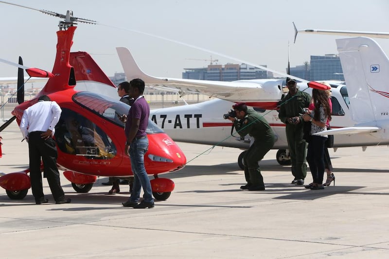 Visitors mill around a small helicopter on the third day of the Abu Dhabi Air Expo. Fatima Al Marzooqi / The National