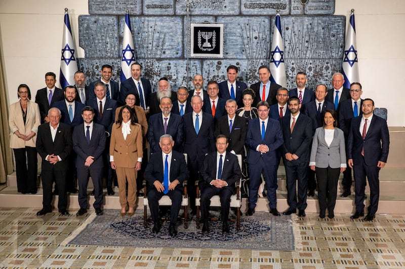 President Isaac Herzog and Prime Minister Benjamin Netanyahu with members of the new Israeli government. Reuters