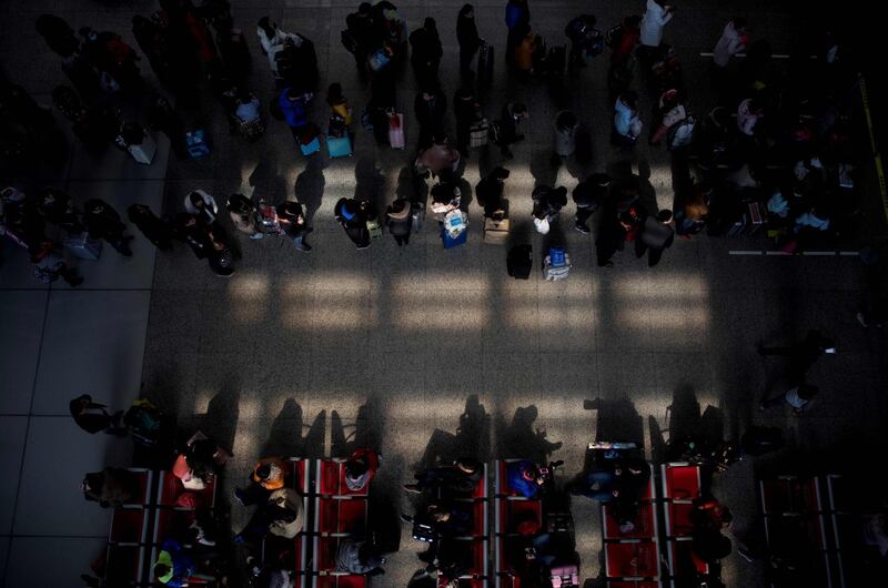 Passengers gather in the waiting hall at Hongqiao Railway Station ahead of the Lunar New Year holidays in Shanghai. Johannes Eisele / AFP