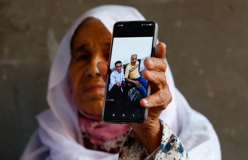 A Palestinian woman in the Gaza Strip displays a picture of her relatives, who had been living in Libya, that were among the victims of the flooding. Reuters