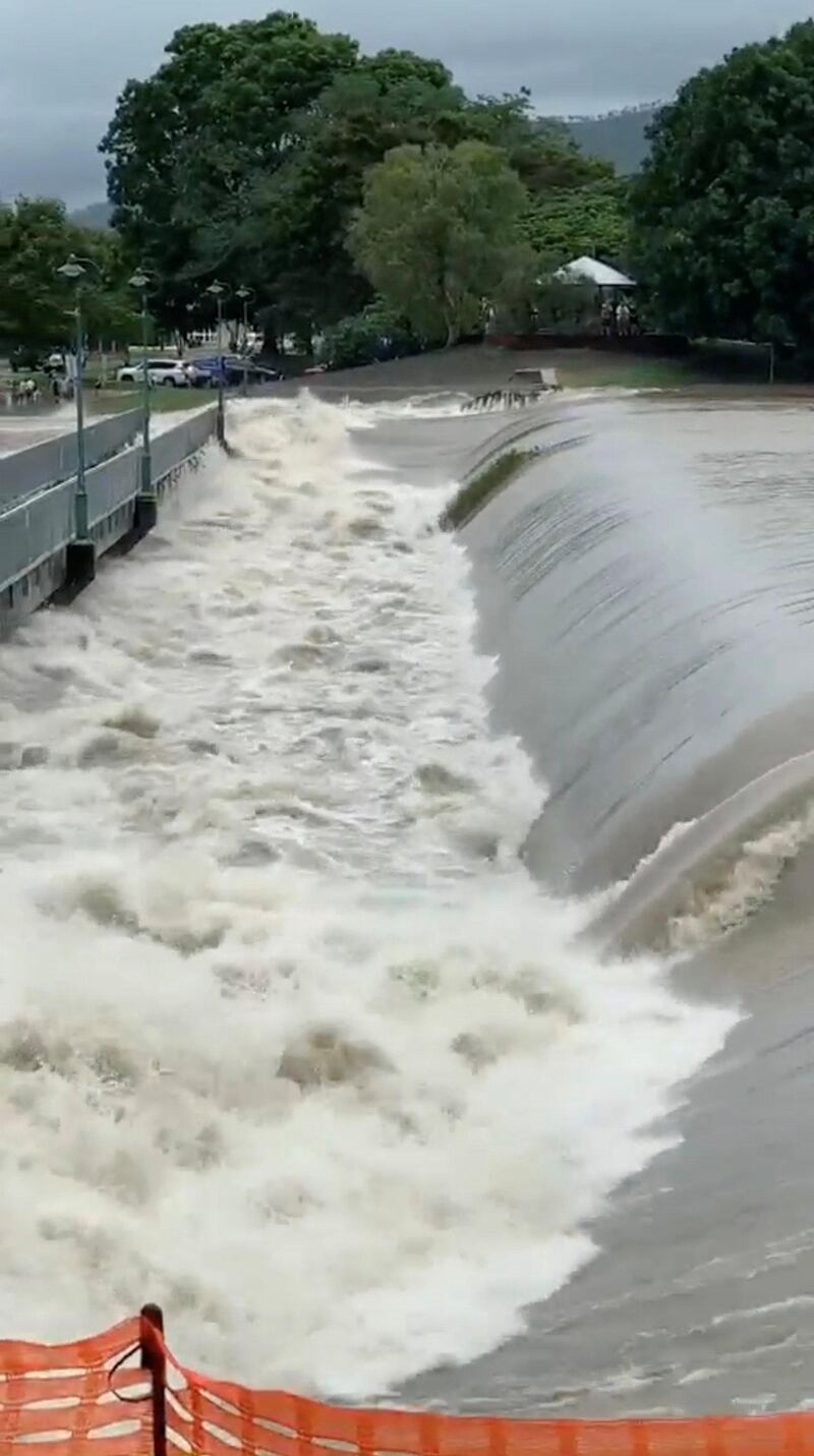 Floodwater flows by the Aplins Weir Rotary Park footbridge in Mundingburra district, Townsville. Reuters