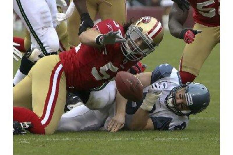 Seattle Seahawks quarterback Matt Hasselbeck is tackled by 49ers linebacker Travis LaBoy.