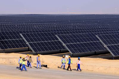 Employees at a solar power plant in Al Dhafra, Abu Dhabi on January 31. It is not hyperbole to suggest the technologies at the heart of green finance will change, or even save, the world. AFP