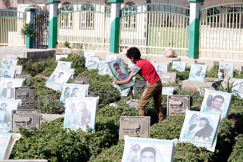 epa09249612 A Yemeni boy holds a picture of his relative at a cemetery dedicated to those who were allegedly killed in the country's ongoing conflict, in Sana'a, Yemen, 05 June 2021. An Omani delegation arrived in Houthi-held Sanaâ€™a, in fresh diplomatic efforts to persuade Houthi leaders to accept a UN proposal of nationwide ceasefire and to get involved in US and UN-sponsored peace talks with the Saudi-backed Yemeni government. Yemen's conflict erupted in 2014 when the Houthis seized control of the west and north of the country, including the capital Sanaâ€™a. It has been exacerbated since March 2015 after the Saudi-led coalition intervened to restore Yemenâ€™s internationally recognized government, claiming the lives of more than 233,000 people.  EPA/YAHYA ARHAB