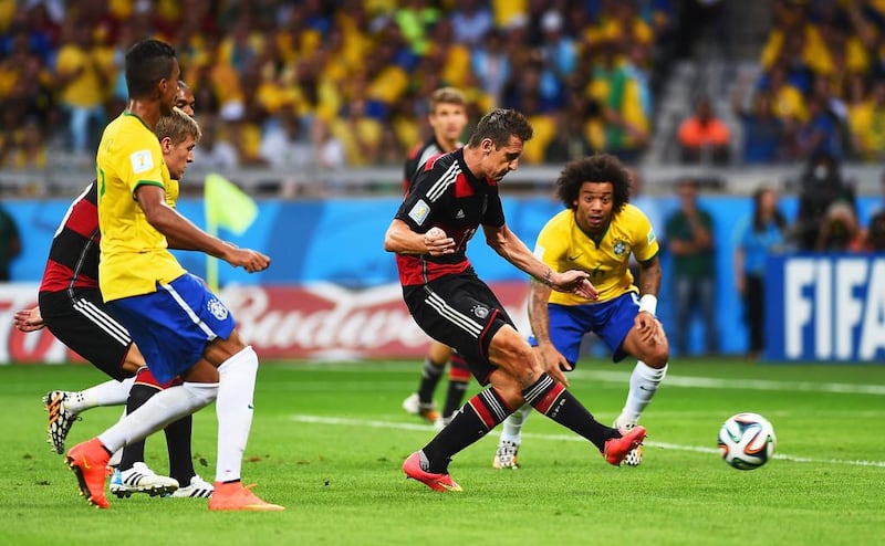 Germany’s Miroslav Klose, second right, scores his team’s second goal in a lop-sided semi-final win over Brazil on Tuesday. Laurence Griffiths / Getty Images

