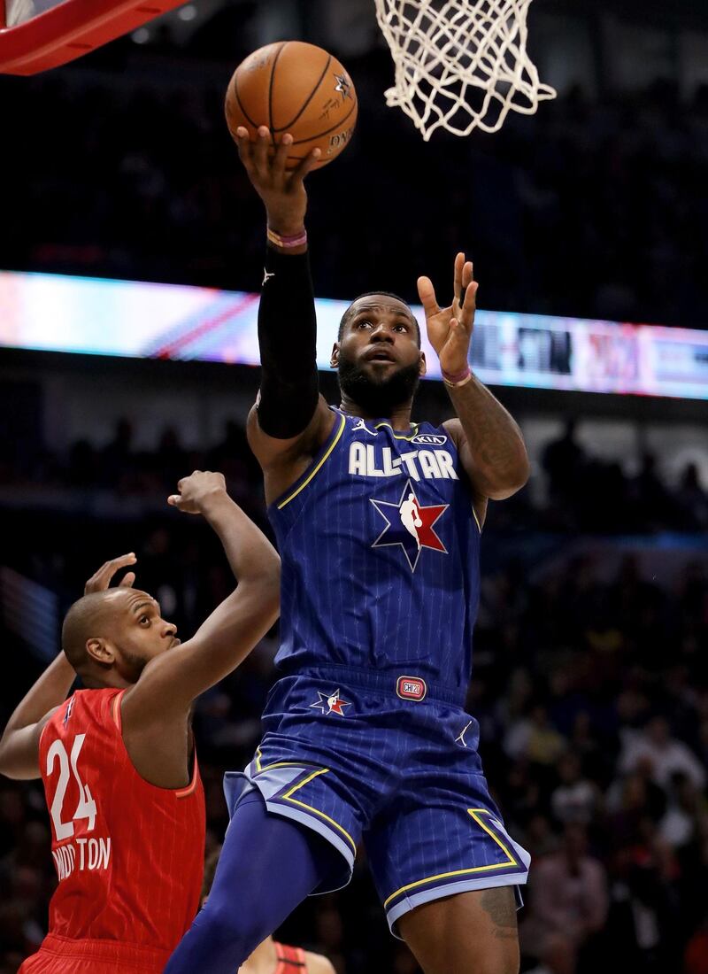 LeBron James attempts a layup past Khris Middleton. AFP