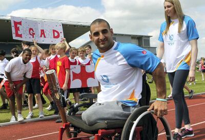 LEEDS, ENGLAND - JUNE 12:   (EDITORIAL USE ONLY, NO SALES)  In this handout image provided by Glasgow 2014 Ltd, Baton bearer Ali Jawad carries the Queen's Baton at the John Charles Centre for Sport on June 12, 2014 in Leeds, England.  England is nation 69 of 70 nations and territories the Queen's Baton will visit. (Photo by David Cheskin/Glasgow 2014 Ltd via Getty Images)