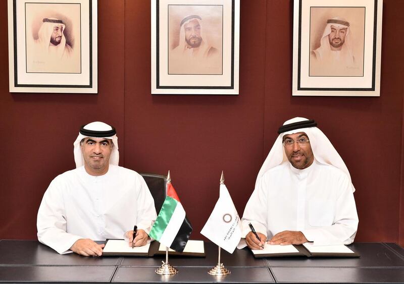 Hamad Abdullah Al Shamsi, left, the chairman of Abu Dhabi Securities Exchange, and Ahmed Al Sayegh, the chairman of Abu Dhabi Global Market during the signing of memorandum of understanding between the two bodies. Courtesy photo