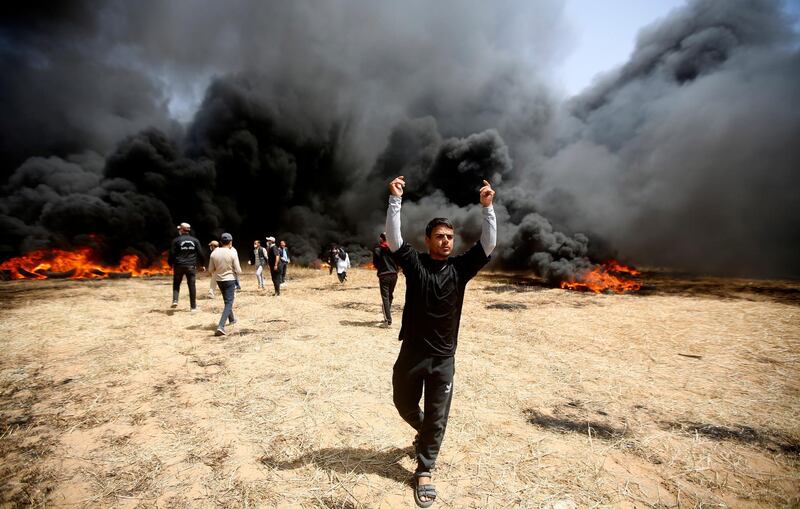 Palestinian protesters burn tyres during clashes with Israeli troops. Adel Hana / AP Photo