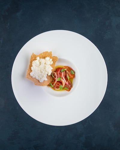 An appetiser of smoked tomatoes, ricotta, honey and Sardinian bread, served at Olympe. Courtesy Olympe.