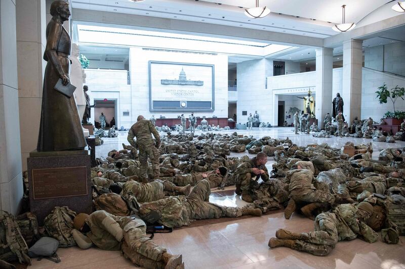 Members of the National Guard rest in the Capitol Visitors Center on Capitol Hill in Washington, DC.  AFP