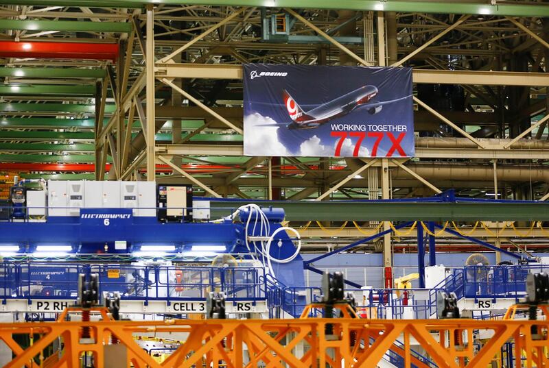 A large 777X banner is seen hanging over the final assembly building floor.