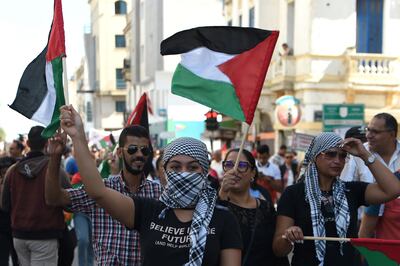 People wave the Palestinian flag during a protest to express their solidarity with Gaza in the Tunisian capital. AFP