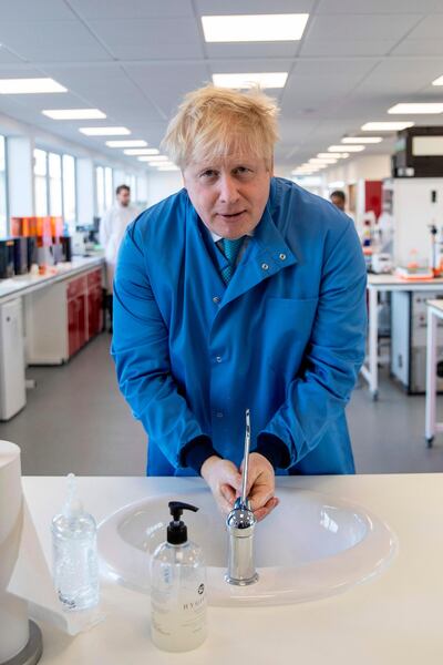 Britain's Prime Minister Boris Johnson washes his hands during a visit to the Mologic Laboratory in the Bedford technology Park, north of London on March 6, 2020. The Prime Minister pledged a further £46 million for research into a coronavirus vaccine and rapid diagnostic tests during the visit to the Laboratory, where British scientists are working on ways to diagnose coronavirus.
 / AFP / POOL / Jack Hill
