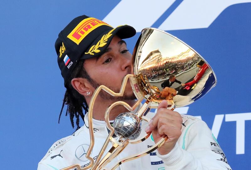 Formula One F1 - Russian Grand Prix - Sochi Autodrom, Sochi, Russia - September 29, 2019  Mercedes' Lewis Hamilton celebrates by kissing a trophy on the podium after winning the race  REUTERS/Anton Vaganov