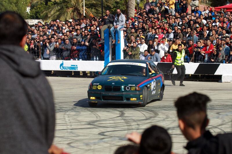 Spectators watch a driver put his drifting skills to the test during a competition in Benghazi, Libya. BMWs are a popular brand among drifting enthusiasts. AFP