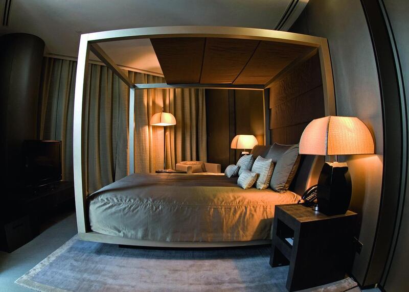 Hotel rooms, such as this one in the Armani Dubai, offer an uplifting experience. You can achieve the same effect in your home by getting rid of clutter, and investing in high-quality bedding and custom-made curtains. Jeff Topping / The National