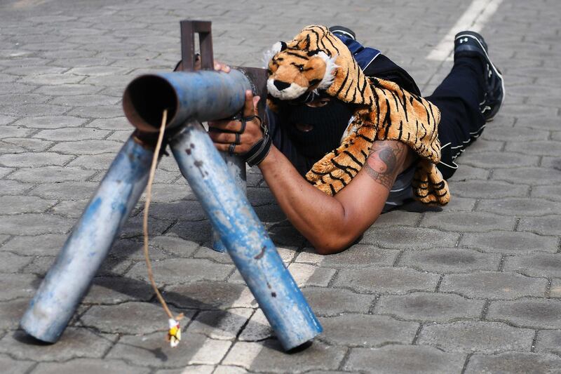 A member of the "April 19" movement demonstrates how to use his home-made mortar launcher in Masaya, about 40 km from Managua, Nicaragua. Marvin Recinos / AFP