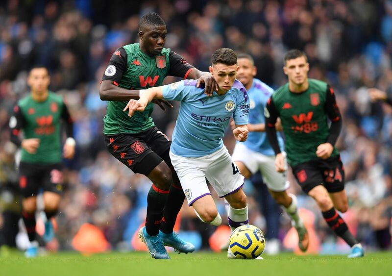 Manchester City's English midfielder Phil Foden (C) vies for the ball against Aston Villa's Zimbabwean midfielder Marvelous Nakamba (2nd L) during the English Premier League football match between Manchester City and Aston Villa at the Etihad Stadium in Manchester, north west England, on October 26, 2019. (Photo by Paul ELLIS / AFP) / RESTRICTED TO EDITORIAL USE. No use with unauthorized audio, video, data, fixture lists, club/league logos or 'live' services. Online in-match use limited to 120 images. An additional 40 images may be used in extra time. No video emulation. Social media in-match use limited to 120 images. An additional 40 images may be used in extra time. No use in betting publications, games or single club/league/player publications. / 