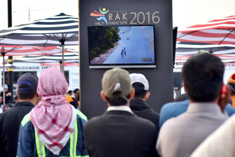 RAK half marathon runners’ families watch the race on big LED screens.