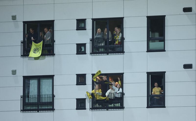 Bodo / Glimt fans watch from their windows outside the stadium. Action Images
