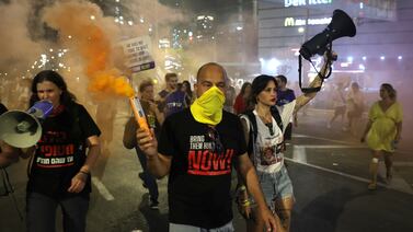 People light flares during an anti-coalition protest outside the Kirya military headquarters in Tel Aviv. EPA