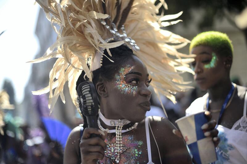 LONDON, ENGLAND - AUGUST 25: Revellers and paraders attend the Notting Hill carnival on August 25, 2019 in London, England. One million people are expected on the streets in scorching temperatures for the Notting Hill Carnival. The Metropolitan Police have a large security operation in place, including "significantly more" knife arches than last year, to deliver what they hope will be a "safe and spectacular" festival. (Photo by Peter Summers/Getty Images)