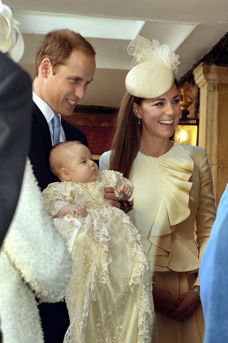 LONDON, ENGLAND - OCTOBER 23:  Prince William, Duke of Cambridge and Catherine, Duchess of Cambridge talk to Queen Elizabeth II (obscured) as they arrive, holding their son Prince George, at Chapel Royal in St James's Palace, ahead of the christening of the three month-old Prince George of Cambridge by the Archbishop of Canterbury on October 23, 2013 in London, England. (Photo by John Stillwell - WPA Pool /Getty Images)
