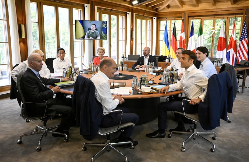 Clockwise from centre: Olaf Scholz; Joe Biden; Boris Johnson; Fumio Kishida; European Commission President Ursula von der Leyen, European Council President Charles Michel; Mario Draghi; Canada's Prime Minister Justin Trudeau, and Emmanuel Macron listen to an online address by Ukraine's President Volodymyr Zelenskyy at the G7 summit in Bavaria. Reuters