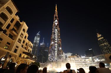 Burj Khalifa and the Dubai Fountain lit up with new Eid light show in Downtown Dubai on Tuesday. Pawan Singh / The National