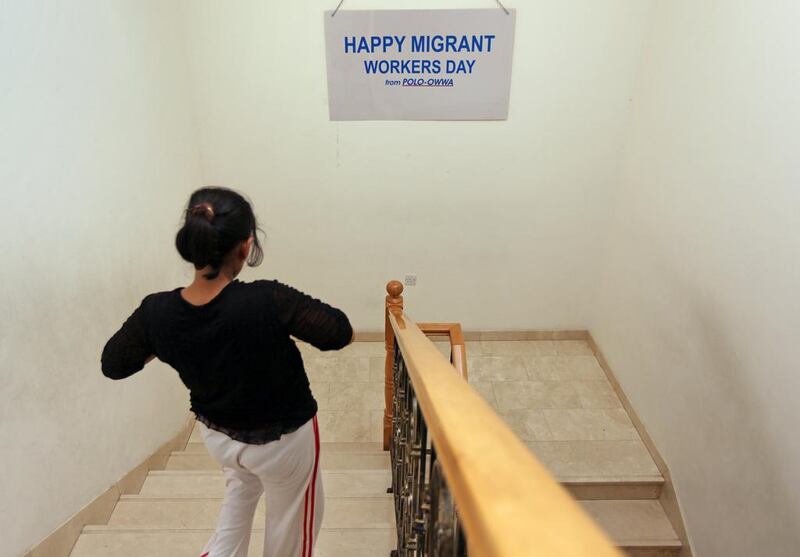 A domestic worker who ran away from her abusive employer walks down a flight of stairs at a safe house in Dubai. Amy Leang / The National