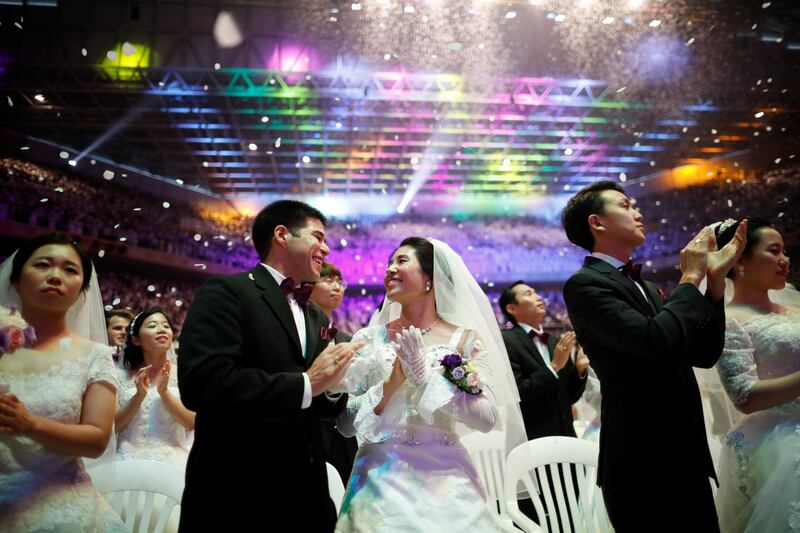 Newlywed couples celebrate their marriage. Kim Hong-ji / Reuters