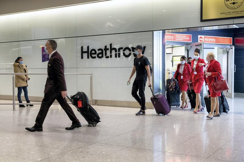 LONDON, ENGLAND - DECEMBER 22:  Passengers arrive at Heathrow Airport just in time for Christmas in a few days on December 22, 2020 in London, England. London and the South East have entered a 'Tier 4' lockdown as a new coronavirus strain is detected in the lead up to Christmas.  (Photo by Joseph Okpako/Getty Images)