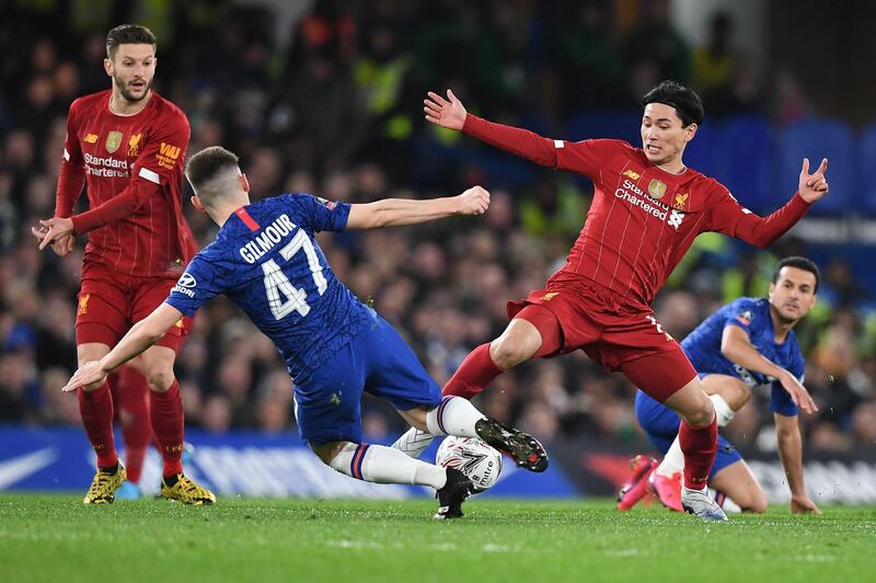 Billy Gilmour lunges into a tackle against Takumi Minamino. AFP