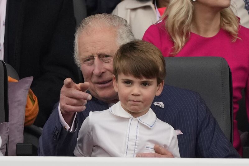 Prince Louis sat on the knee of his grandfather the Prince of Wales during the pageant. PA