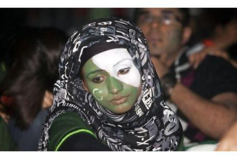 A Pakistani cricket fan in Dubai's Palladium arena watches her team lose to India in last night's semifinal World Cup match.