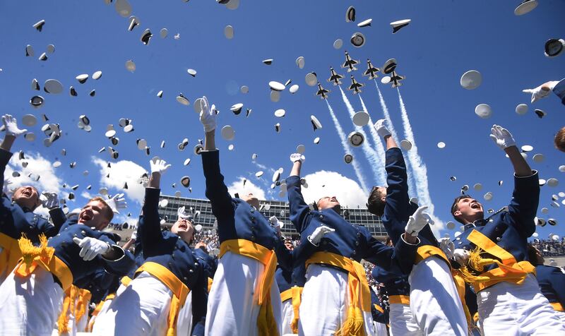 Air Force Academy cadets throw their hats into the air as the Thunderbirds flyover at the end of graduation on Wednesday, May 25, 2022 in Colorado Springs, Colo. .  (Jerilee Bennett / The Gazette via AP)