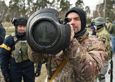 Members of the Ukrainian Territorial Defence Forces examine new weapons, including NLAW anti-tank systems and other portable anti-tank grenade launchers, in Kyiv. AFP