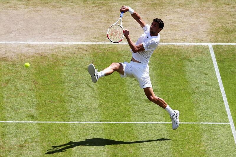 Grigor Dimitrov leaps to make an overhead return during his win over Andy Murray at the 2014 Wimbledon Championships on Wednesday at the All England Club in London, England. Jan Kruger / Getty Images