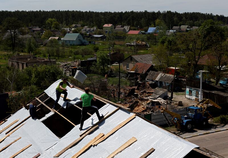 A roof damaged during Russia's invasion of Ukraine is rebuilt in  Moshchun village, near Kyiv. Reuters