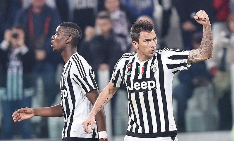 Mario Mandzukic, right, celebrates after scoring the winning goal for Juventus against Empoli. Di Marco / EPA