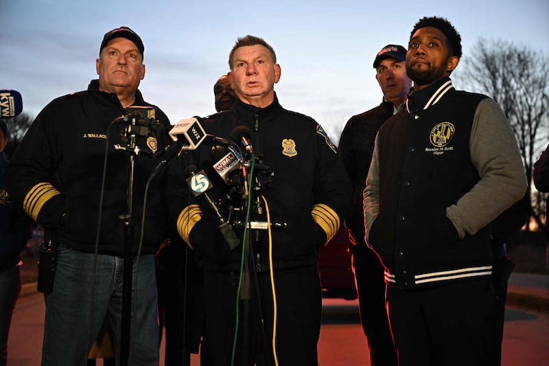 Baltimore Police commissioner Richard Worley, centre, Mayor Brandon Scott, right, and Fire Department chief James Wallace hold a press conference. AFP