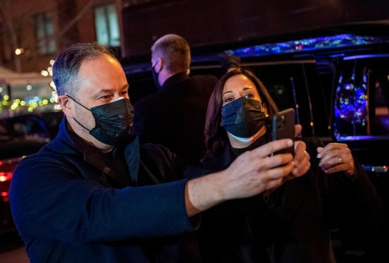 US Vice President-elect Kamala Harris and her husband Doug Emhoff take a selfie outside of Floriana, an Italian restaurant that has been in business over 40 years, during a visit to support the local restaurant amid the Covid-19 pandemic, near Dupont Circle in Washington, DC on January 4, 2021. / AFP / Eric BARADAT
