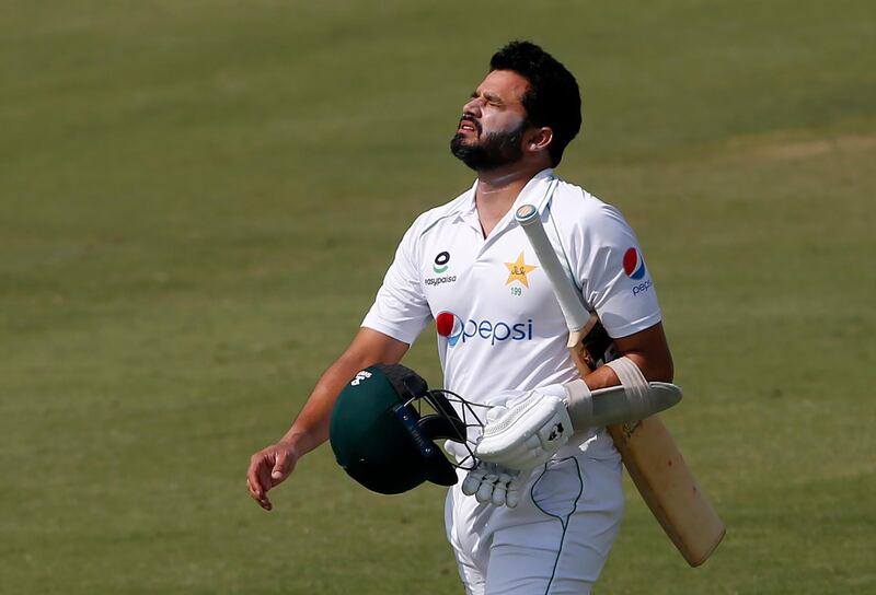 Pakistan's Azhar Ali walks pack to pavilion after being dismissed for 51. AP