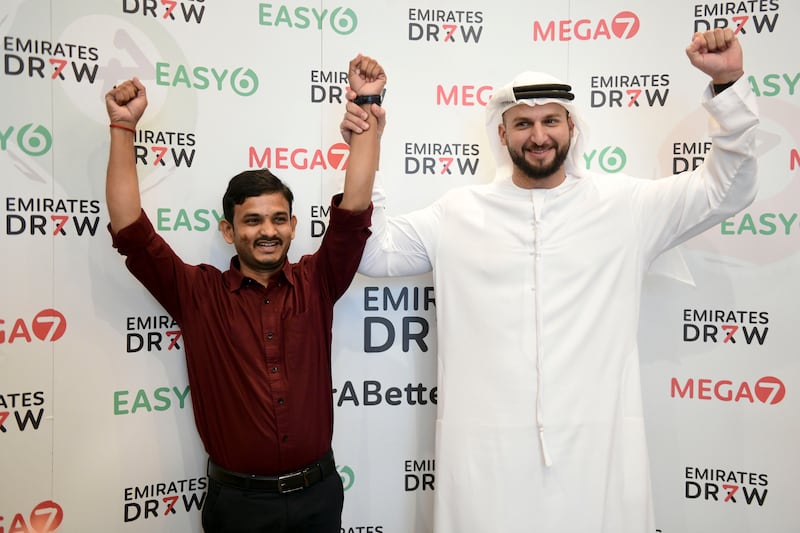 Winner Ajay Ogula celebrates with Emirates Draw spokesman Mohammad Alawadhi. All photos: Khushnum Bhandari / The National

