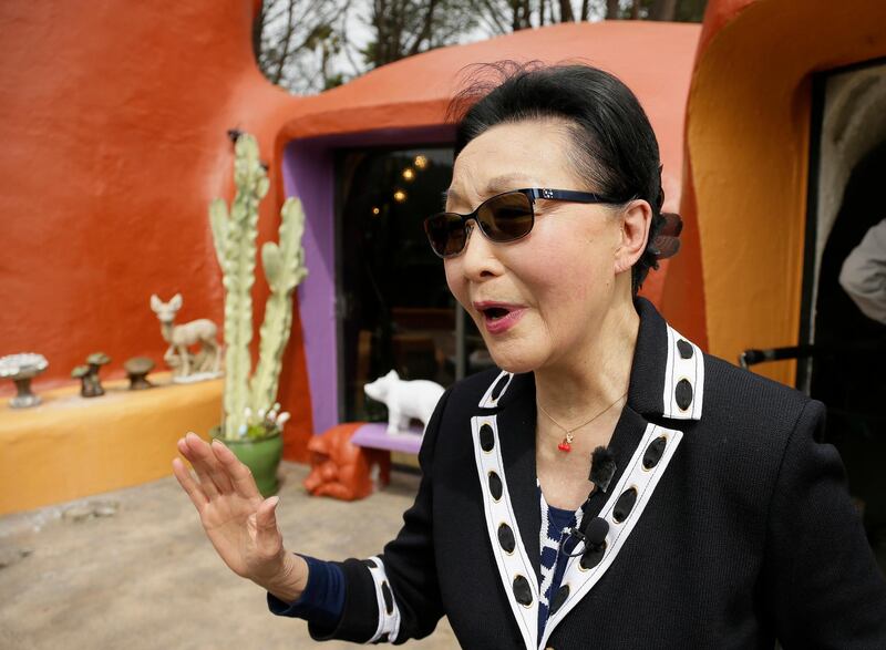 Homeowner Florence Fang talks with reporters after a news conference outside her Flintstone House. AP