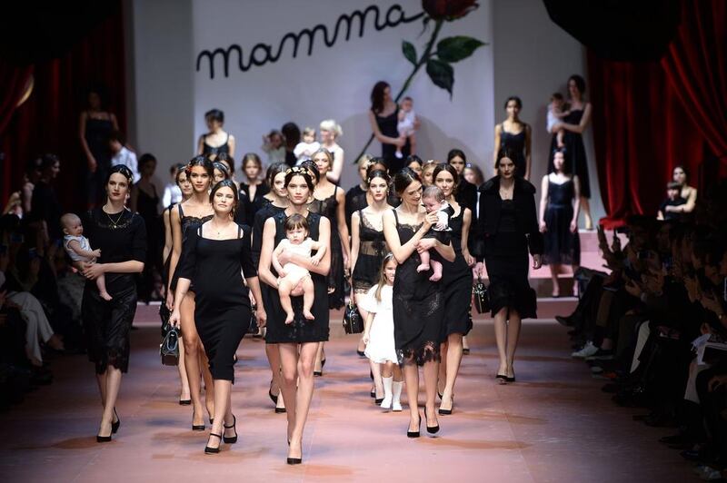 Italian actress Bianca Balti, second left, walks on the catwalk with models at the end of the show for fashion house Dolce & Gabbana at the women Fall / Winter 2015/16 Milan’s Fashion Week on March 1, 2015.  AFP 