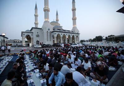 People wait for the sunset to break their fast outside Al Farooq Mosque in Dubai in April 2022. EPA