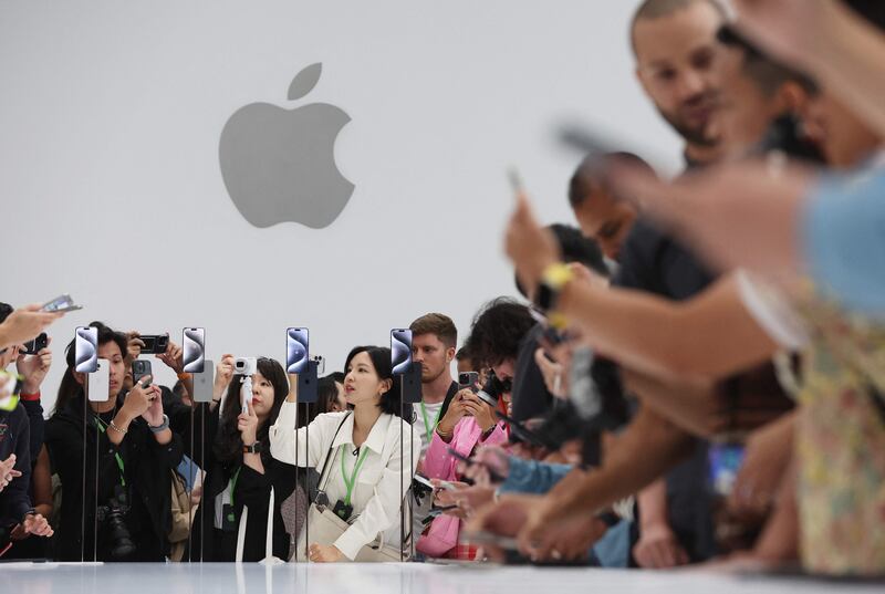 Visitors look at new iPhones during an Apple event in September in Cupertino, California. AFP