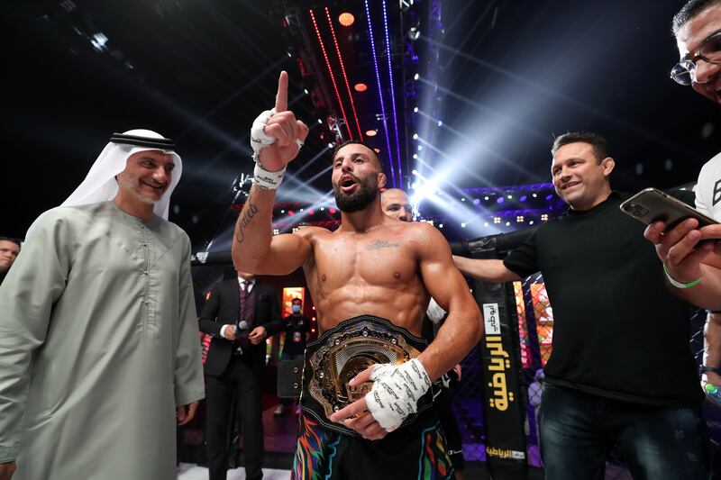 Ali Taleb celebrates his victory against Vincius de Oliveira in the bantamweight title fight at UAE Warriors 30.